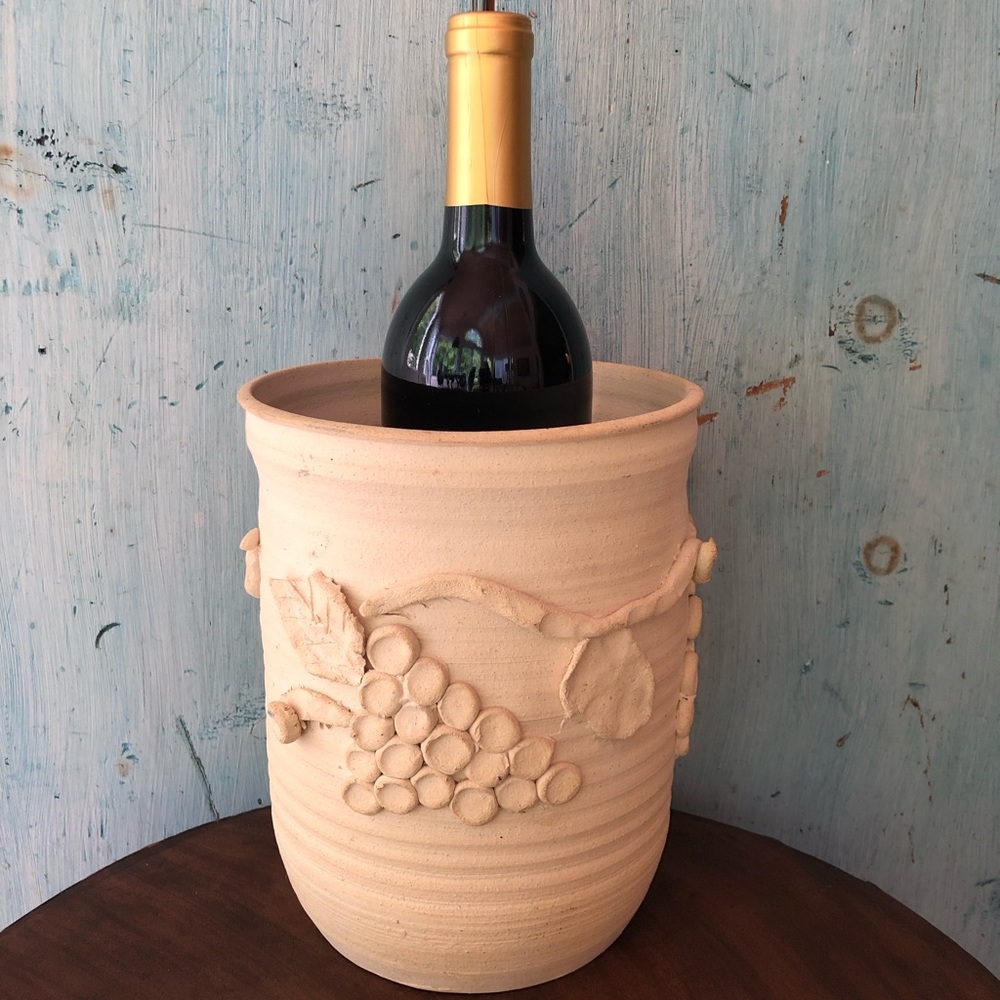 Ceramic wine bucket made by artist in off-white with raised grape bunches